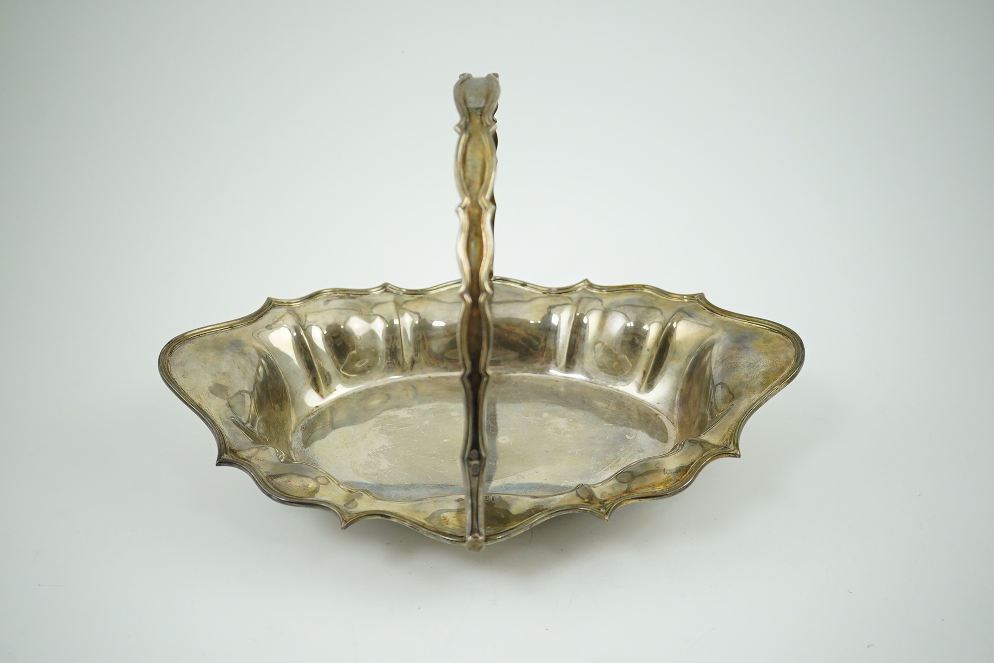 An Edwardian silver cake basket, by William Comyns & Sons Ltd